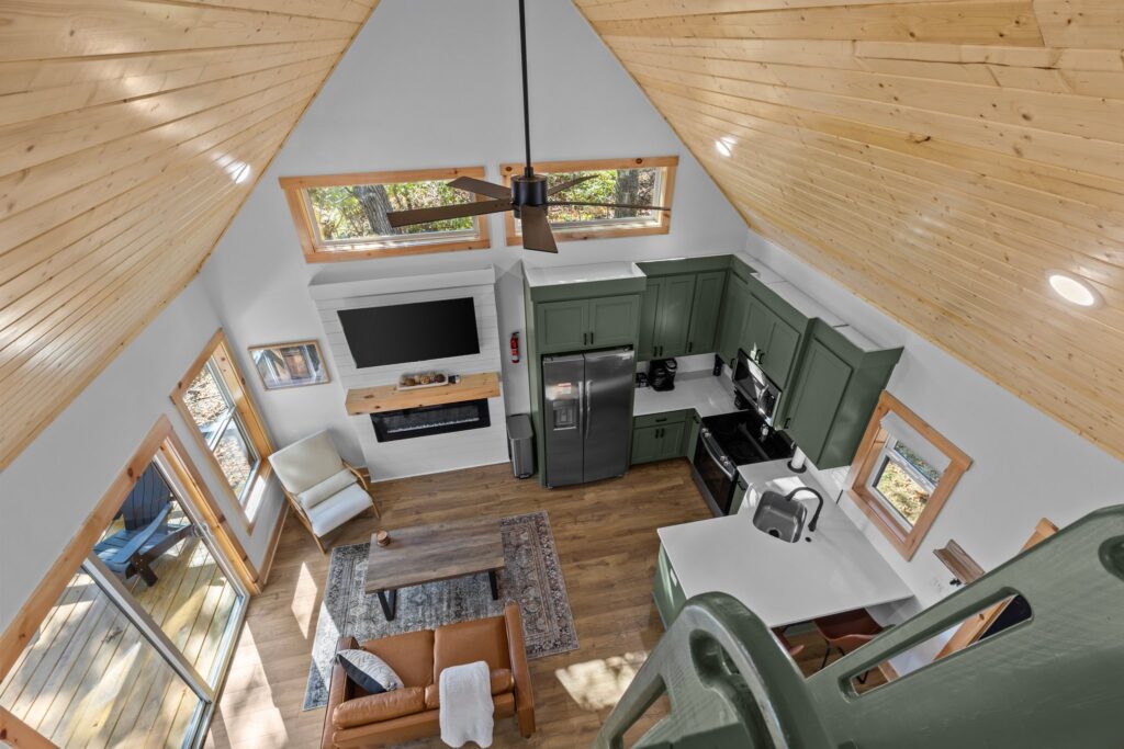 Kitchen and living area beneath the vaulted wood ceiling