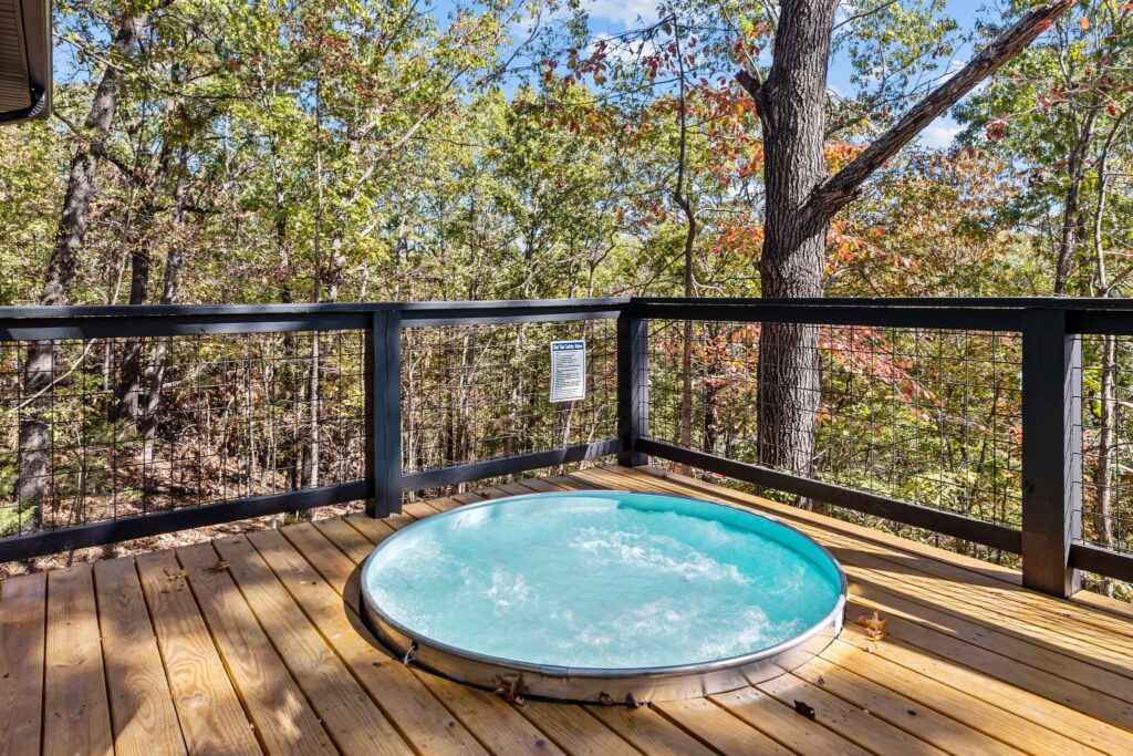 Private hot tub on the deck surrounded by trees